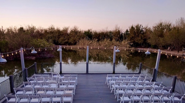 Chairs set up for wedding on deck overlooking lake