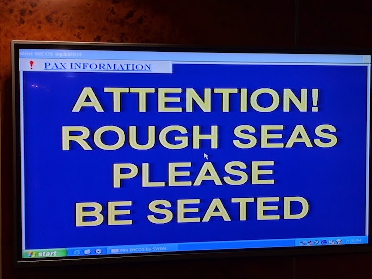"Rough seas, please be seated" sign