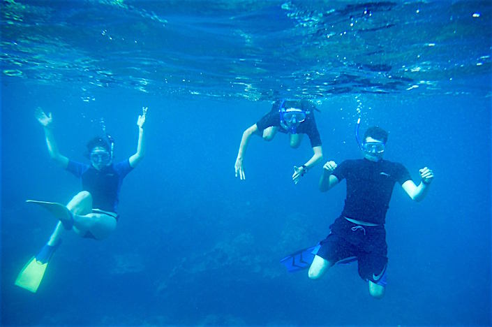 three people snorkeling