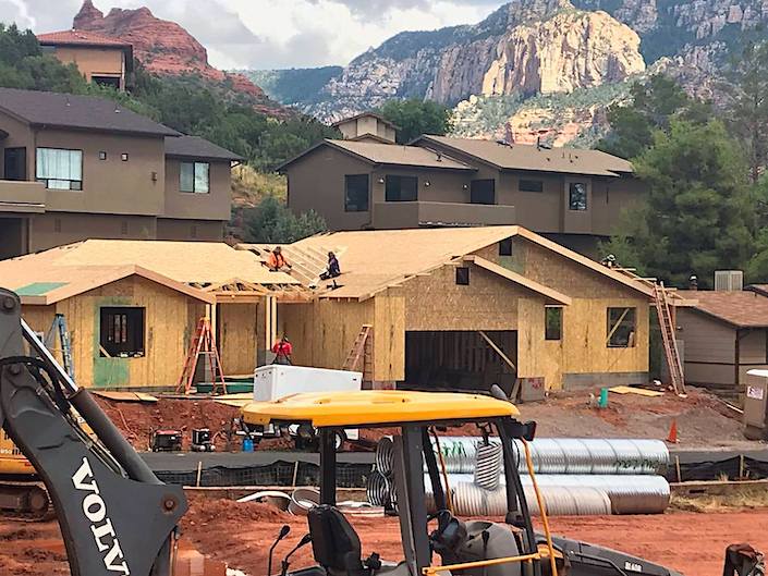 house being built - red rocks behind it